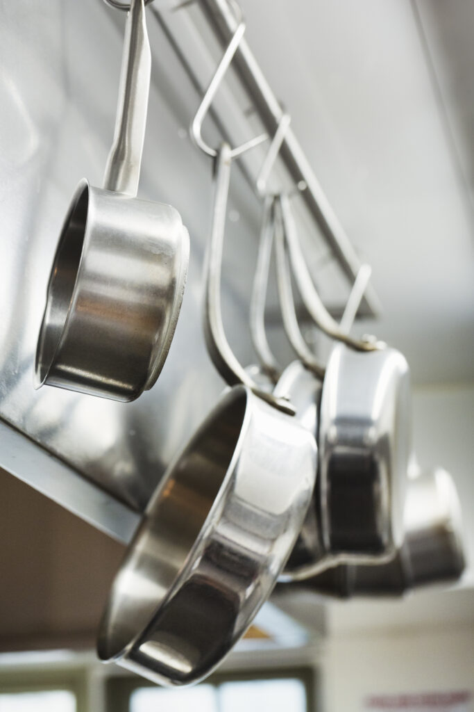 Maximize Your Small Spaces by using hanging pot racks in your kitchen